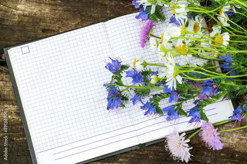 Beautiful wild flowers and a notebook for recording