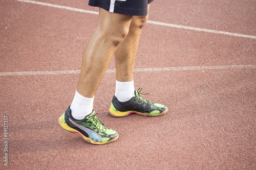 Sprinter at track, close up of legs and shoes.