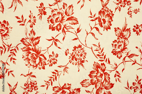 Floral pattern on white fabric. Graphic red roses print as background.