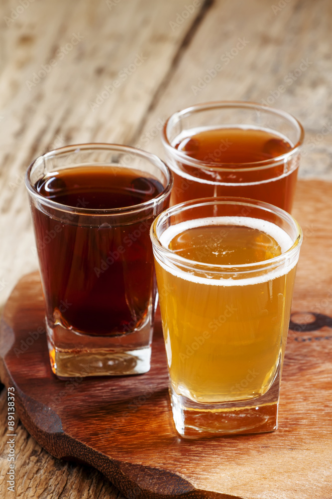 Three kinds of beer on old wooden background, selective focus Three kinds of beer on old wooden background, selective focus