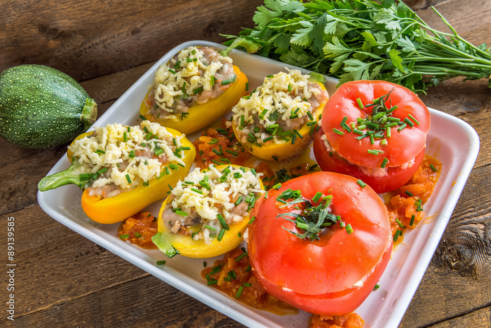 Stuffed vegetables before baking on wooden background. Above view Stuffed vegetables before baking on wooden background. Above view