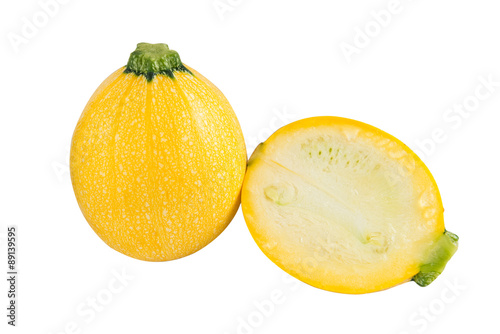 Raw round yellow zucchini and a cut one on a white background. Isolated