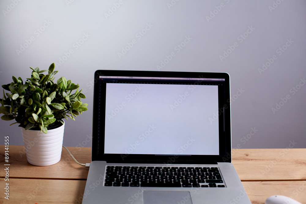 a stack of papers on the desk with a computer