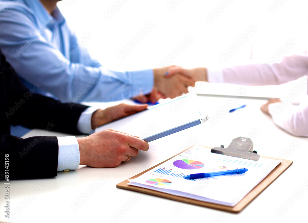 Business meeting at the table shaking hands conclusion of the Business meeting at the table shaking hands conclusion of the