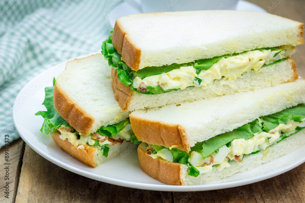 Sandwich with egg salad, bacon, green onion and lettuce Sandwich with egg salad, bacon, green onion and lettuce
