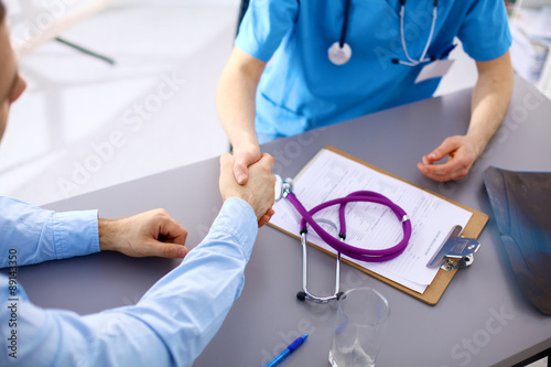 doctor with stethoscope on the patient's admission at the table