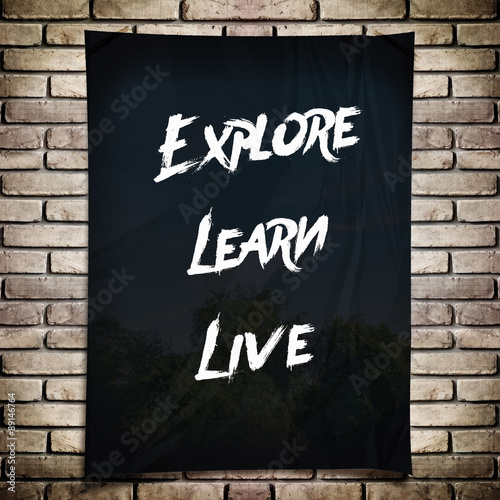 Inspiration quote : " Explore learn live" on black crumpled pape