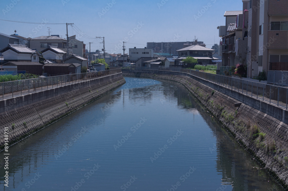 Osaka street with traditional houses next to a yodogawa river