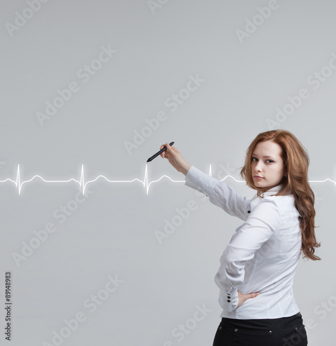 doctor woman drawing cardiogram