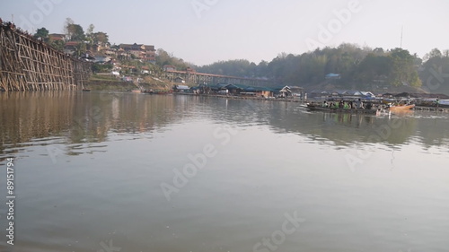 Tourist on boat near bamboo bridge at Samprasob river,Kanchanaburi Thailand photo