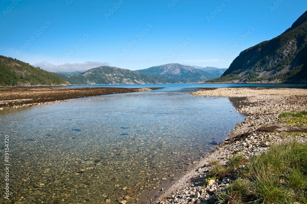 River estuary in Tosen fjord. Scenic landscape in Bindal in Nordland, Norway on a sunny summer day.