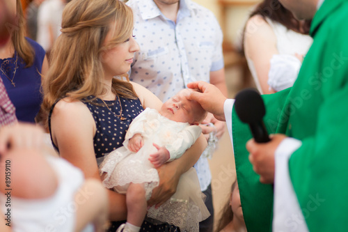 Fotografie Little girl on ceremony of child christening in church