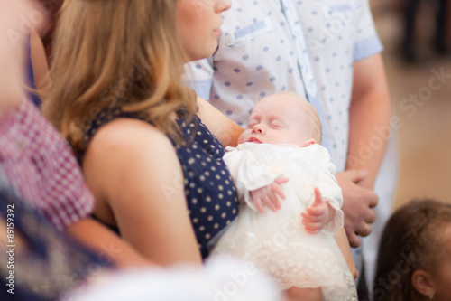Girl on mother hands, christening