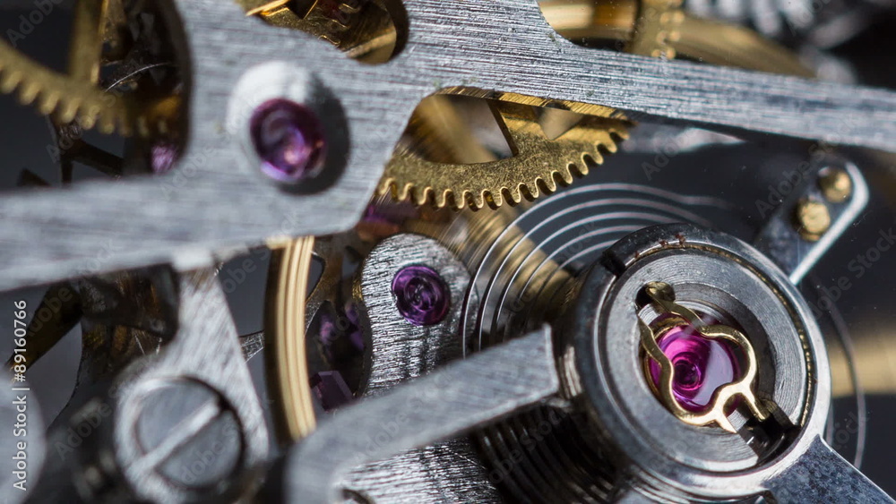 Rack focus macro shot of a clockwork with gearwheels.