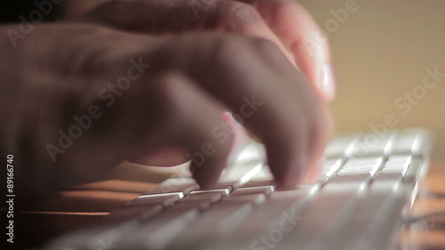 Hands typing on the remote wireless computer keyboard