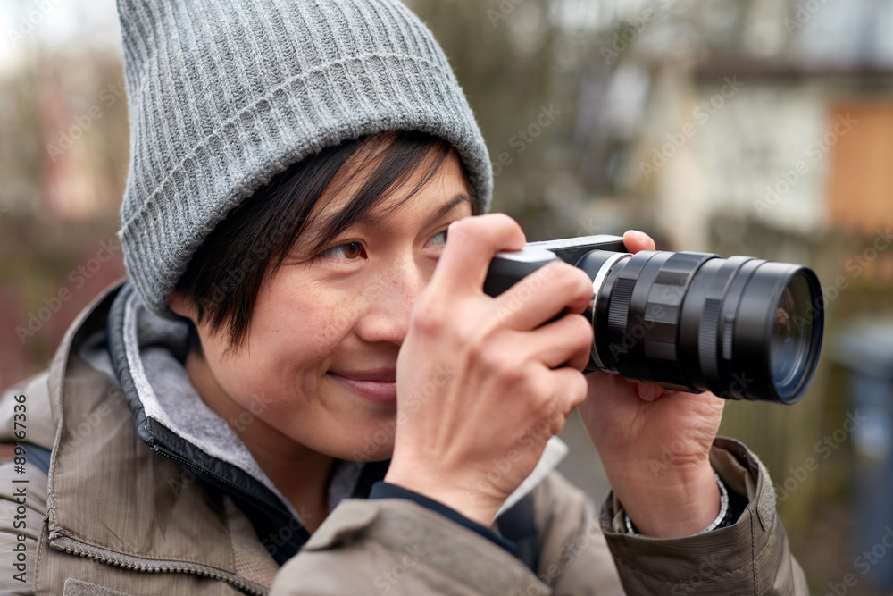 Fototapeta premium Woman taking picture with camera