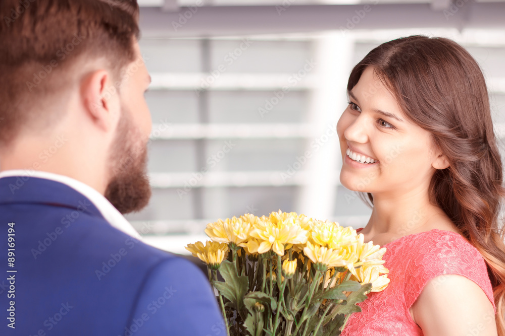 Man presenting flowers to his girlfriend Man presenting flowers to his girlfriend