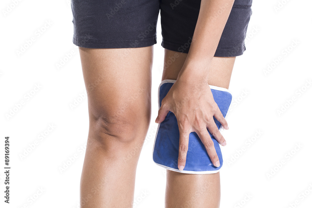 woman applying cold pack on swollen hurting knee