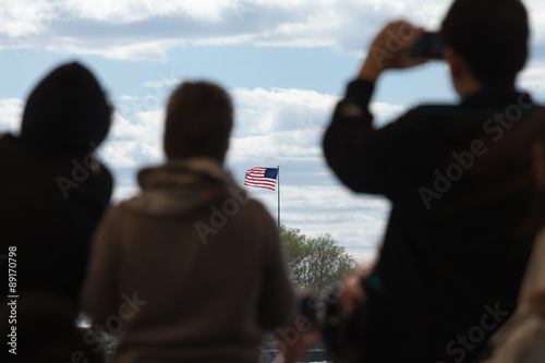 Travelers looking at the US flag photo