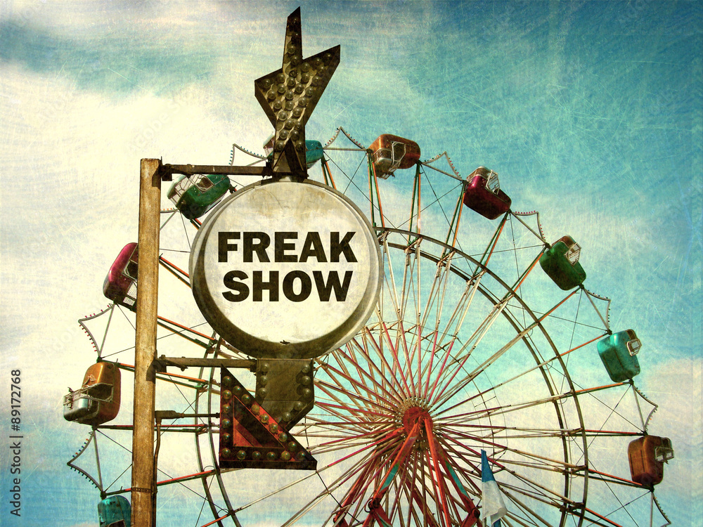 Fototapeta premium aged and worn vintage photo of freak show sign at carnival
