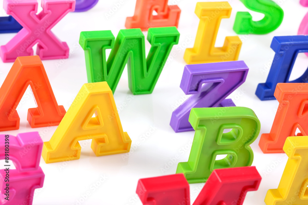 Plastic colorful alphabet letters close up on a white