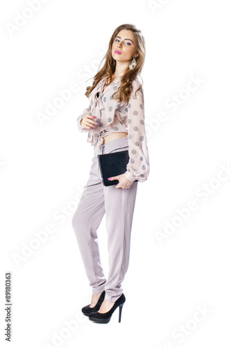 Young beautiful brunette woman in a blouse and pants