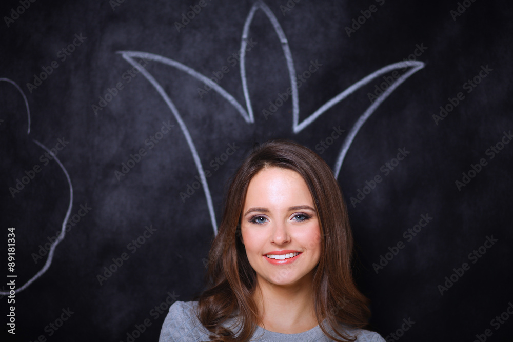 Closeup portrait of beautiful young girl with painted crown