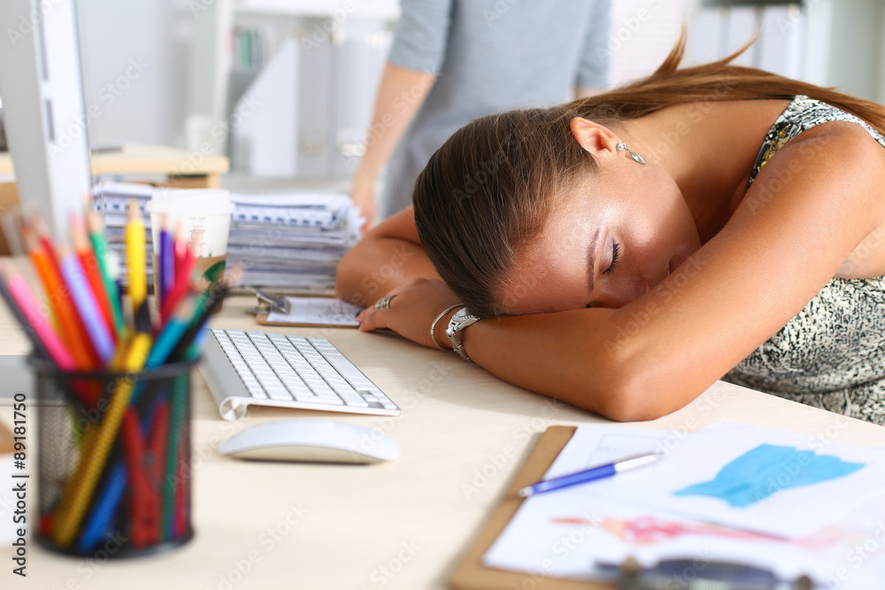 Office life. Young woman sleeping at workplace Office life. Young woman sleeping at workplace