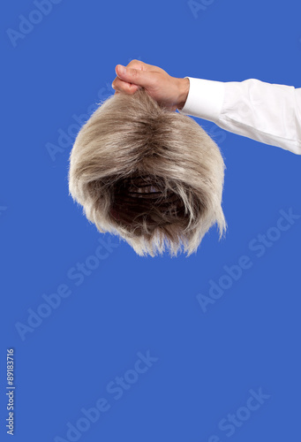 Hand holding a wig