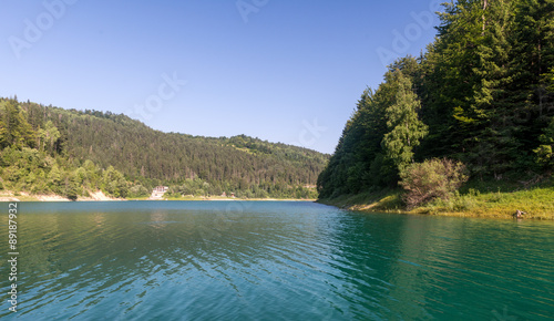  Clear mountain lake and rocky mountains in late summer.