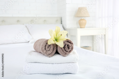 Freshly laundered fluffy towels in bedroom interior