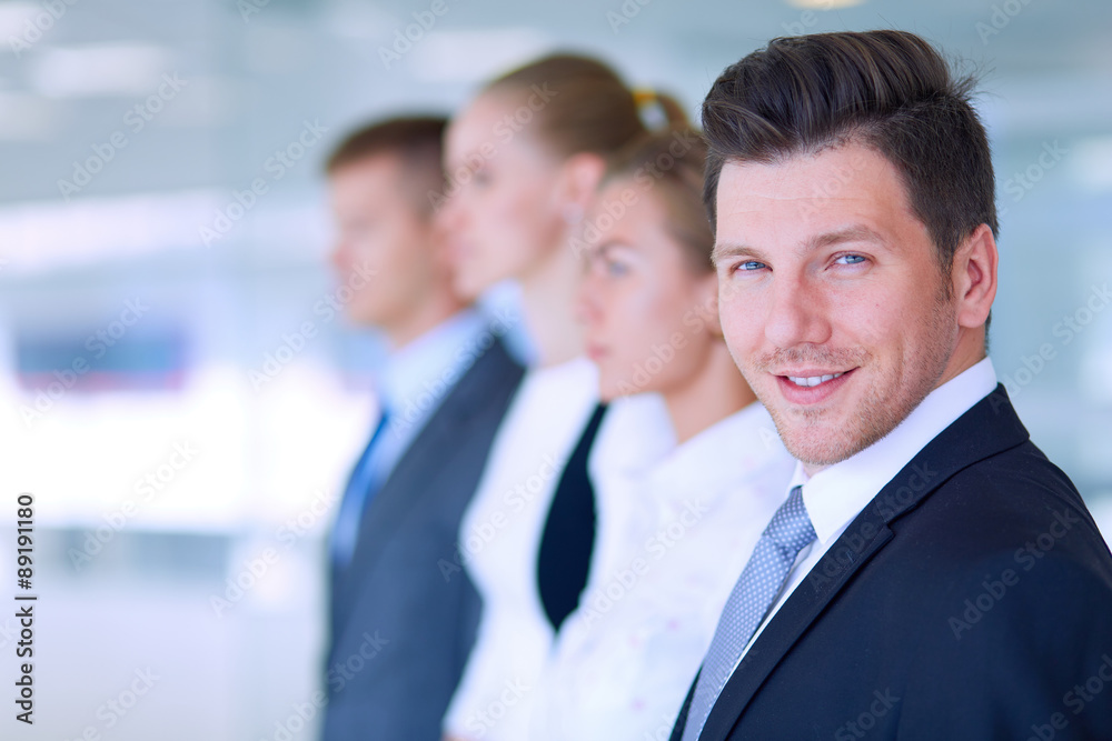 Smiling successful business team standing in office Smiling successful business team standing in office