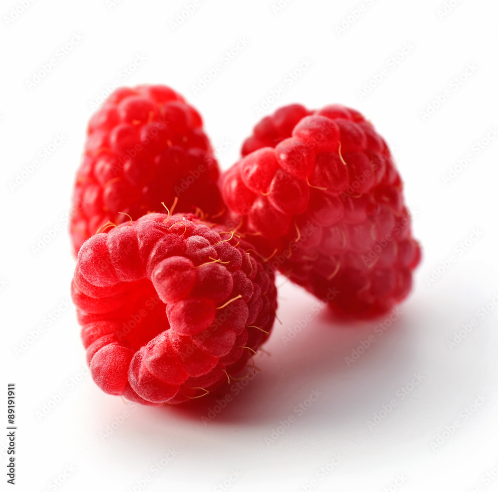 Red sweet raspberries isolated on white Red sweet raspberries isolated on white