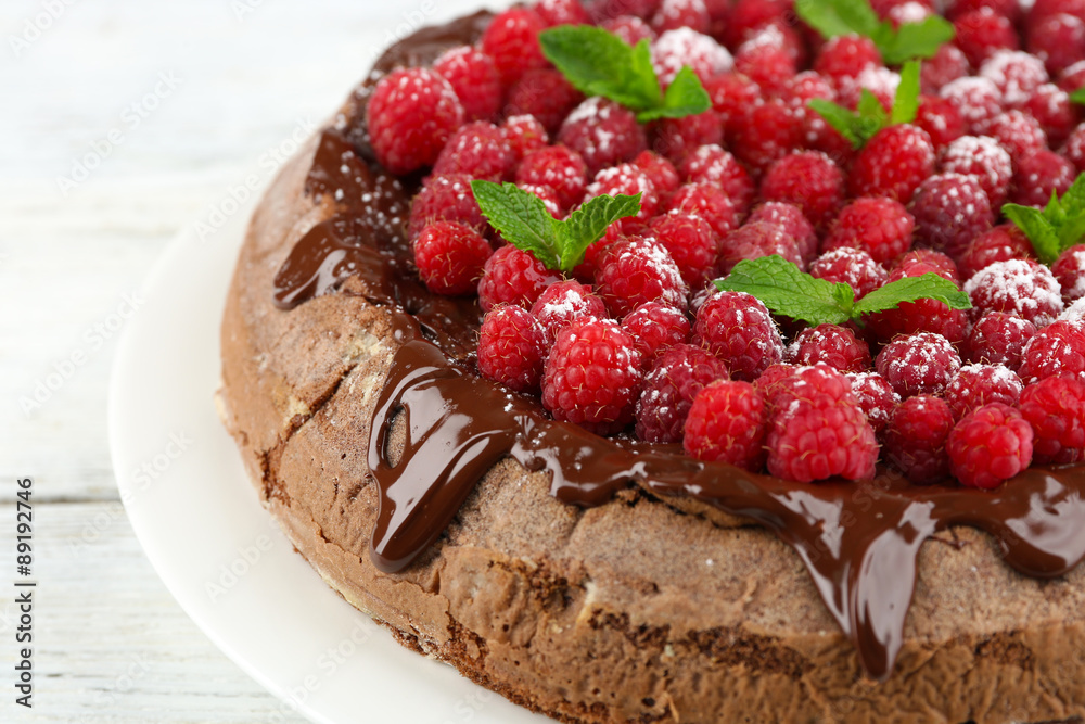 Cake with Chocolate Glaze and raspberries on wooden background Cake with Chocolate Glaze and raspberries on wooden background
