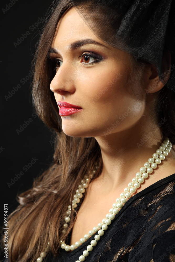 Retro style portrait of young woman on dark background Retro style portrait of young woman on dark background