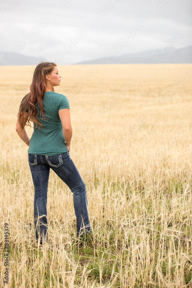 Young woman posing in wheat field.