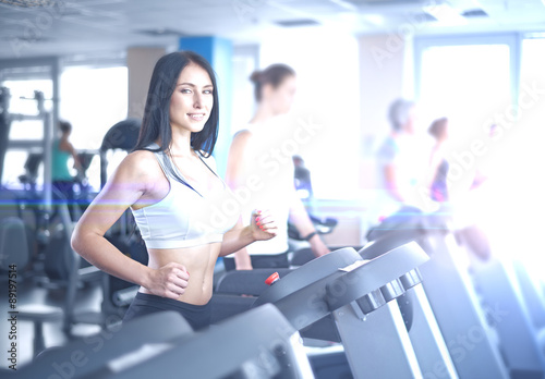 Portrait of pretty girl training on special sport equipment in g