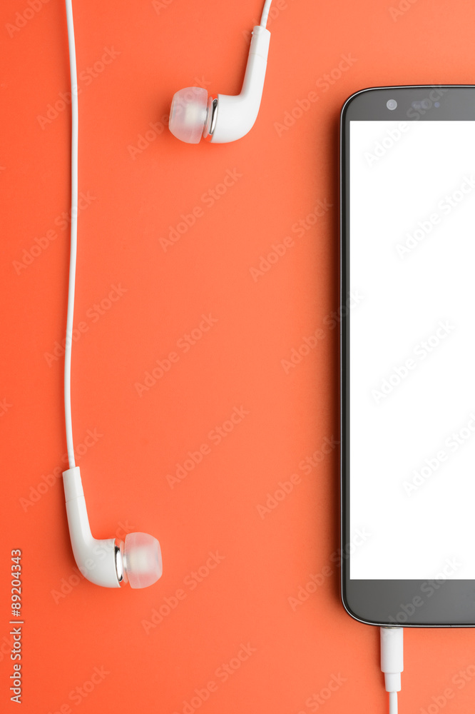 Fototapeta premium Smartphone with connected headphones