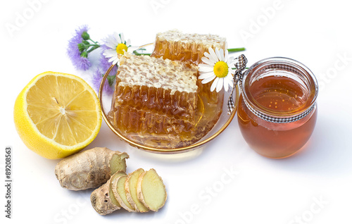 honeycomb, ginger, lemon, chamomile, honey in a glass jar on a w photo