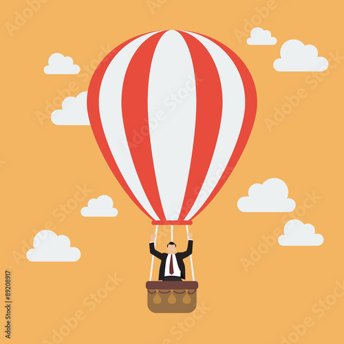 Businessman celebrating in hot air balloon
