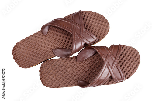 Brown rubber flip flops on a white background