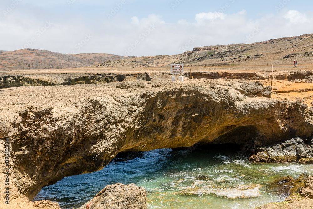 Danger Sign on Natural Bridge on Coast of Aruba