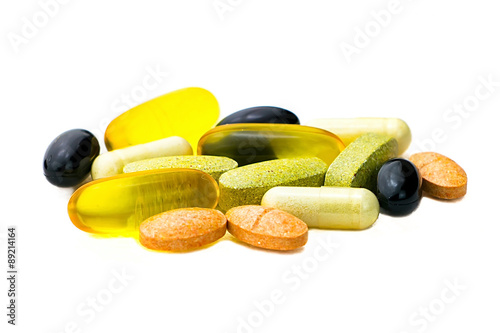 Mixed food supplement pills close-up, omega3, carotine, vitamins photo