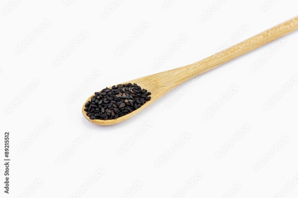 Black Sesame Seeds in wooden spoon isolated on white background Black Sesame Seeds in wooden spoon isolated on white background