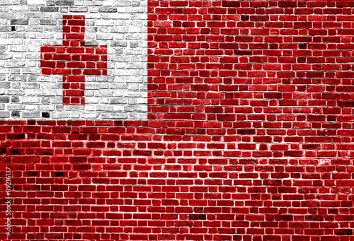 Flag of Tonga painted on brick wall, background texture