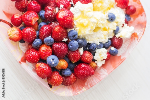 Healthy breakfast cottage cheese with blueberry and strawberry