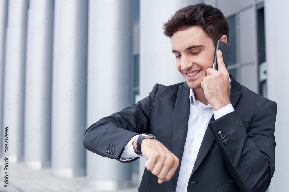 Cheerful young man is talking on the telephone Cheerful young man is talking on the telephone