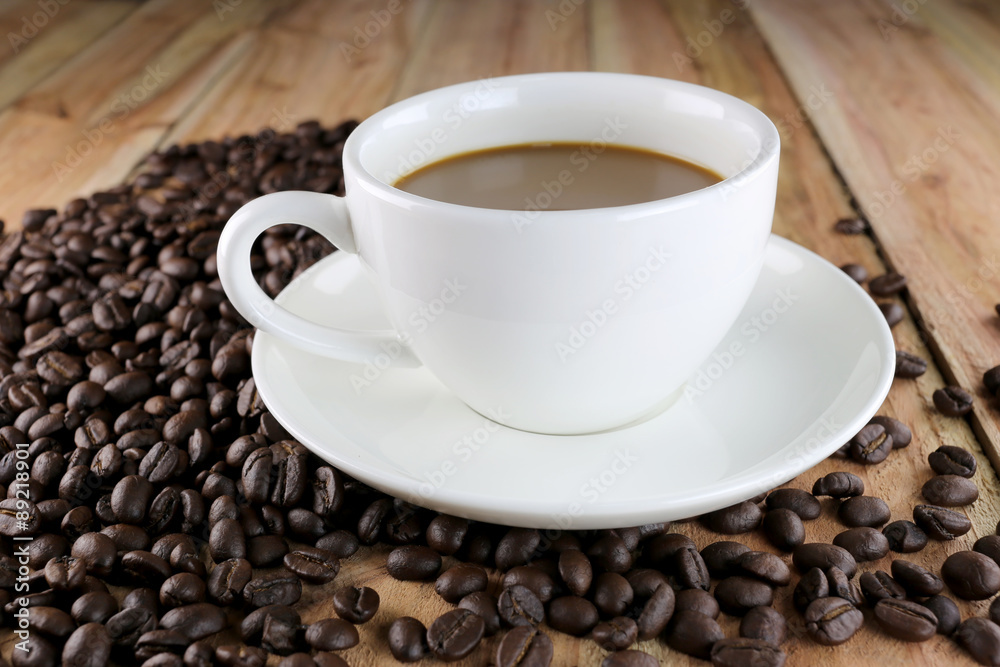 White coffee cup and roasted coffee beans. White coffee cup and roasted coffee beans.