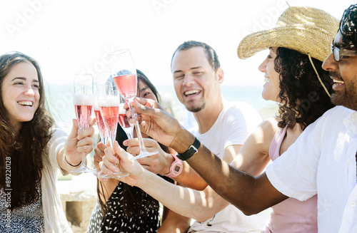 Canvas Print Smiling friends celebrating a special occasion with drinks