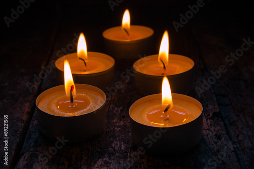 scented candles burning on a black background